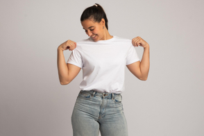 Smiling hispanic girl showcasing a t-shirt mockup