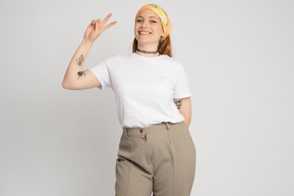 Hispanic girl with bandana doing peace gesture in t-shirt mockup