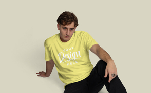 Blonde man sitting t-shirt mockup | Start Editing Online