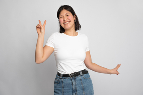 Asian female doing playful gestures in t-shirt mockup