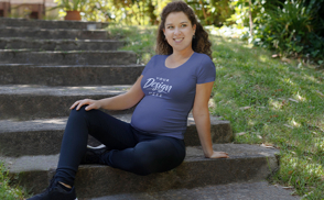 Pregnant woman sitting in stairs t-shirt mockup