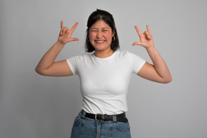 Asian woman making funny gesture in t-shirt mockup