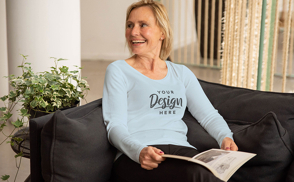 Woman reading a magazine with t-shirt mockup