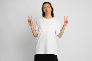 Latin american woman doing peace gesture in t-shirt mockup