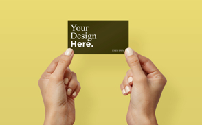 Hands holding business card