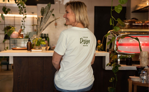 Blonde woman sitting in kitchen t-shirt mockup