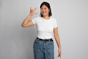 Asian female doing funny gestures in t-shirt mockup