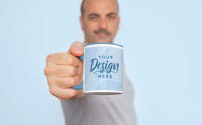 Man holding coffee mug mockup