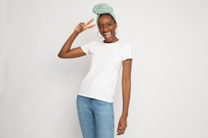 Black female doing a hand gesture in t-shirt mockup