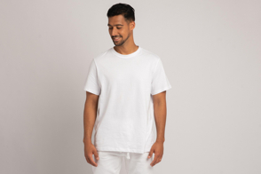 Young hispanic man in white pants and t-shirt mockup