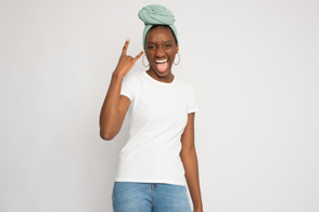 Black female doing rocker gesture in t-shirt mockup