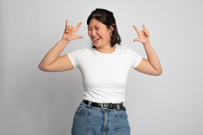 Asian girl making funny gesture in t-shirt mockup