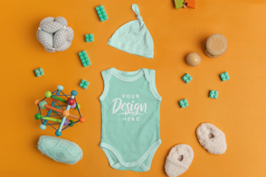 Baby onesie with toys and clothes mockup