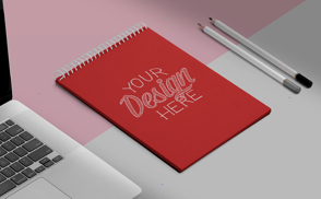 Notebook with laptop and pencils mockup