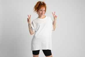 Redhead woman doing peace gesture in t-shirt mockup