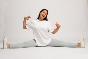 Hispanic woman doing a split in t-shirt mockup