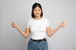 Asian woman doing hand pose in t-shirt mockup