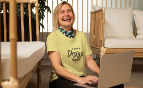 Woman laughing with computer and t-shirt mockup