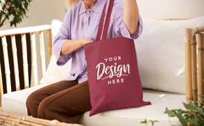 Woman sitting on bench with tote bag mockup