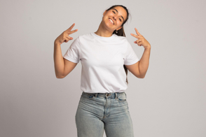 Hispanic woman doing hand gestures in t-shirt mockup