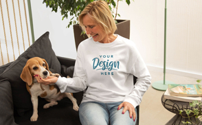 Woman with dog in living room sweatshirt mockup