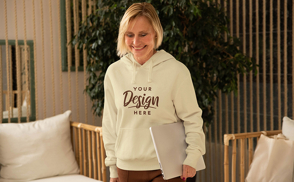 Blonde woman smiling with laptop hoodie mockup