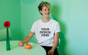 Man smiling sitting in dining room t-shirt mockup