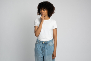 Black woman with thoughtful expression in t-shirt mockup