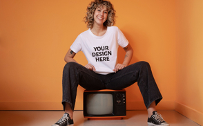 Woman sitting on top of retro tv t-shirt mockup