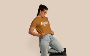 Girl in jeans looking at t-shirt mockup | Start Editing Online