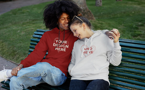 Happy couple sitting on bench hoodie mockup