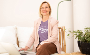 Blonde woman sitting in couch t-shirt mockup