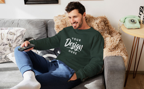 Male model watching tv sweatshirt mockup