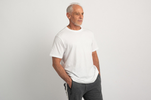 Senior male model with hands in pockets and t-shirt mockup