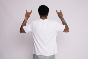 Black man from behind wearing a t-shirt mockup