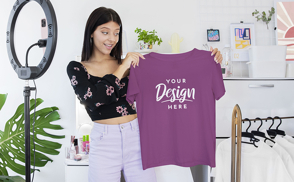 Young woman holding a t-shirt mockup