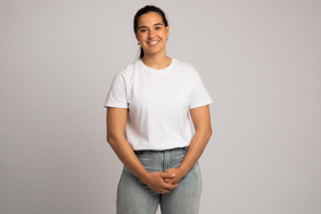 Hispanic girl with hands clasped front in t-shirt mockup