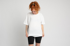 Redhead woman looking down in t-shirt mockup