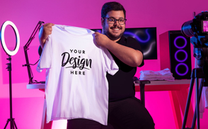 Man smiling and holding a t-shirt mockup