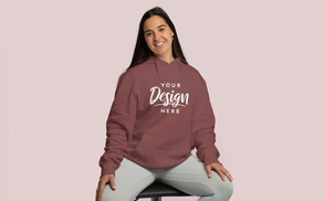 Girl sitting in a chair in a hoodie mockup