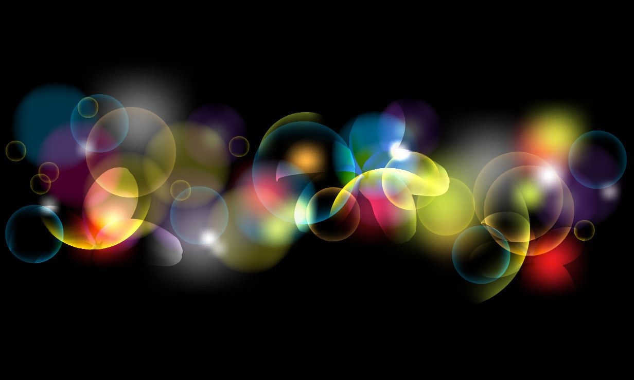 Burbujas de bokeh fluorescentes de colores sobre negro