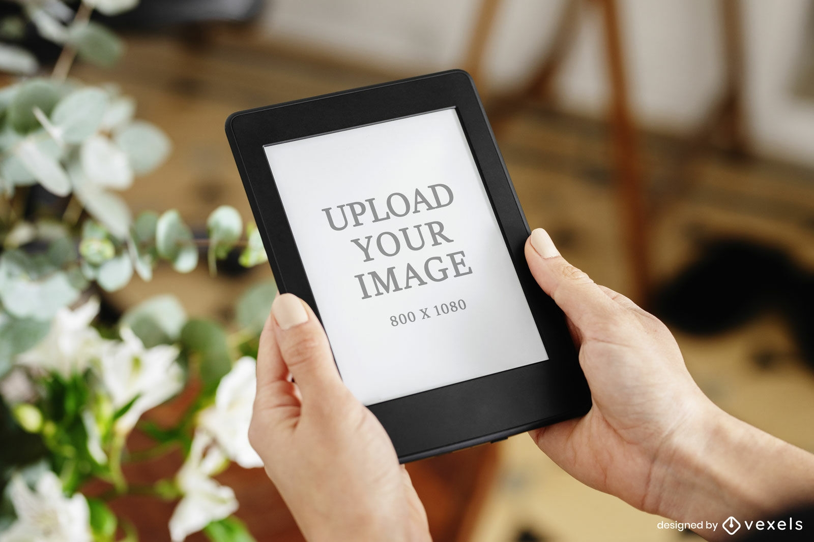 Hands holding kindle mockup with plant