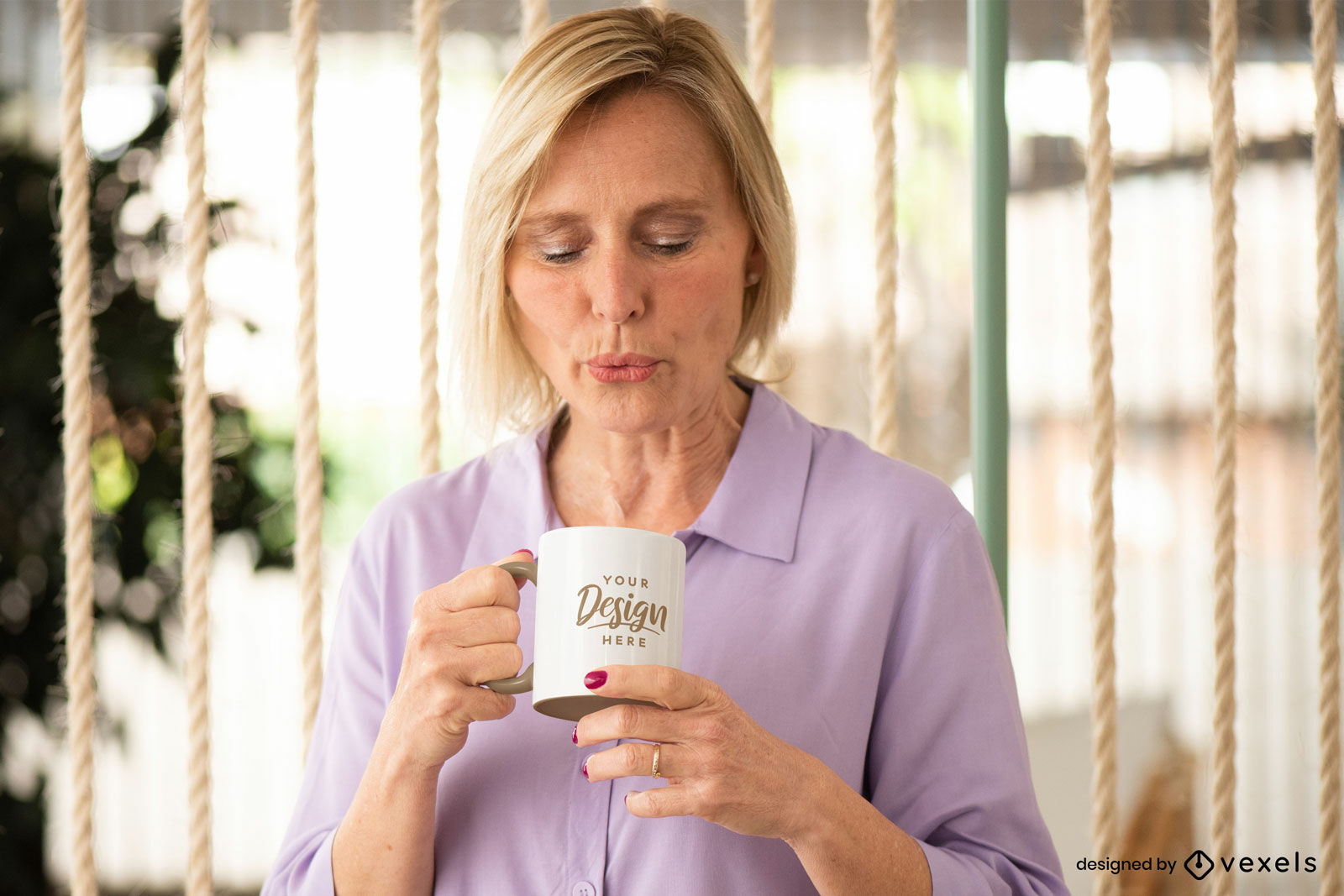 Woman blowing white and yellow mug mockup