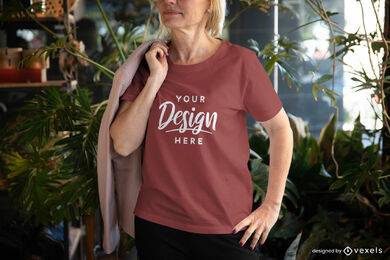 Woman in maroon t-shirt in room with plants mockup