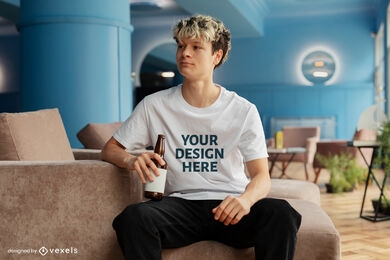 Man in couch drinking t-shirt mockup