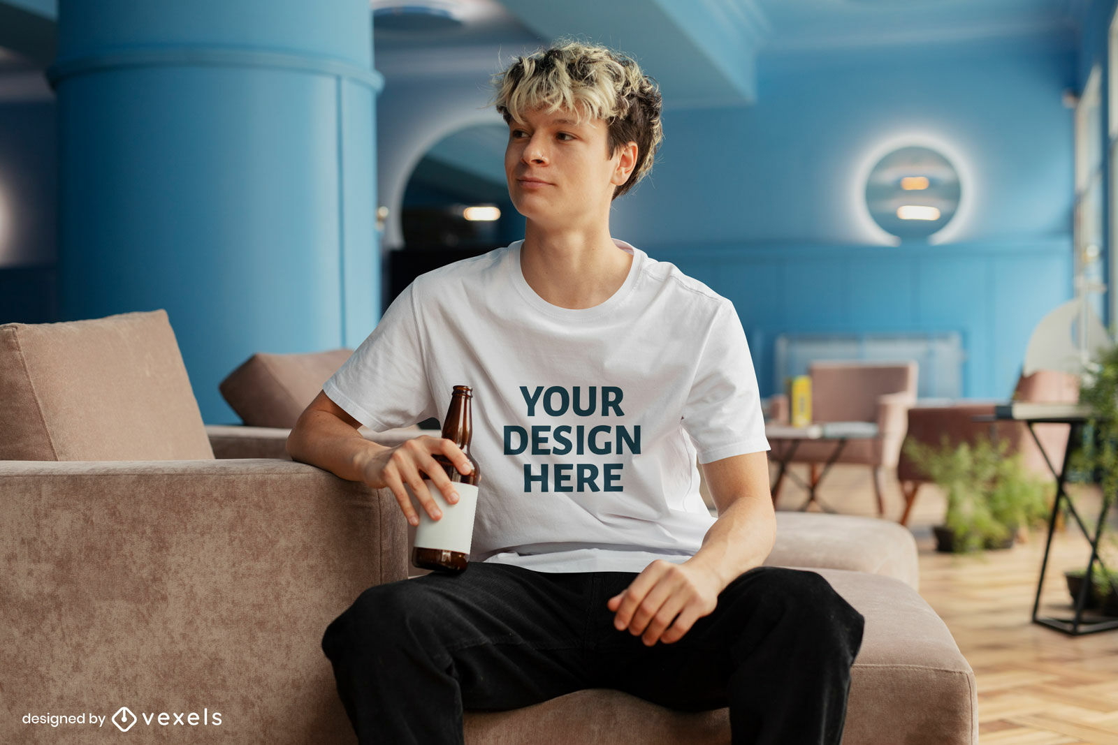 Man in couch drinking t-shirt mockup