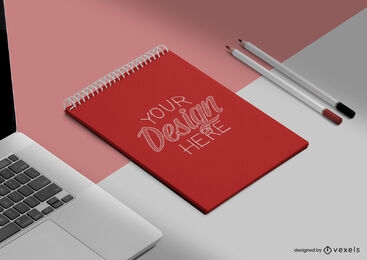 Notebook on desk with pencils and laptop mockup
