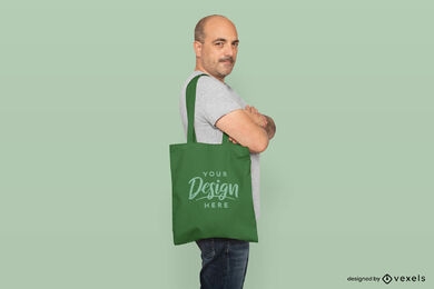 Man posing in solid background with tote bag mockup