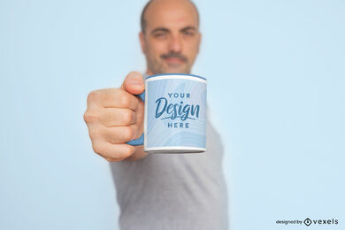 Man holding small mug by handle mockup