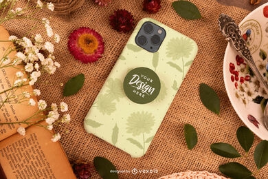 Phone case on table with leaves mockup